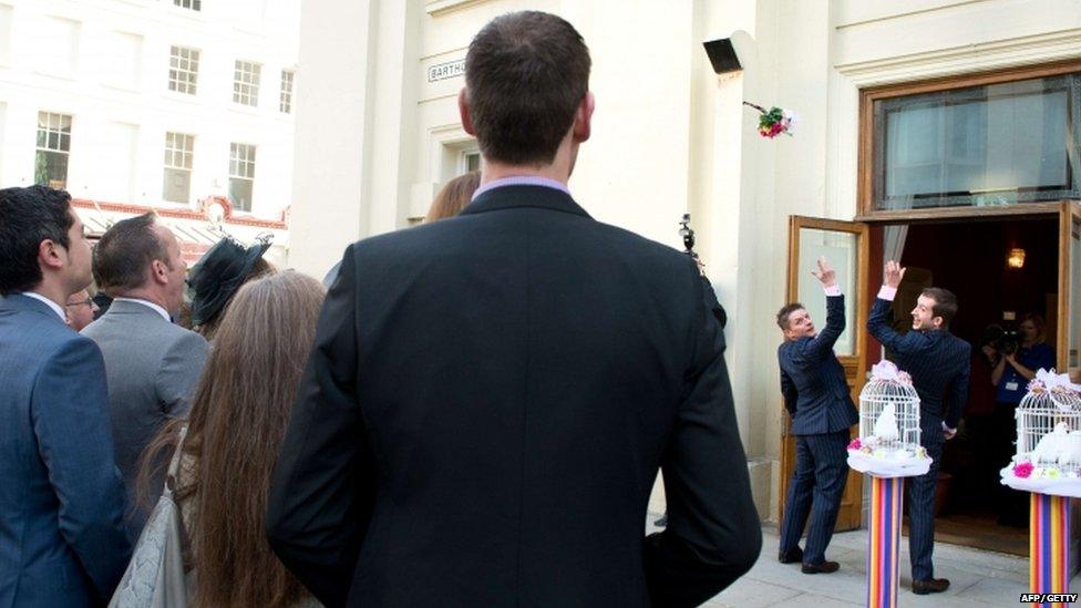 Phil Robathan (left) and James Preston throw the bouquet following their wedding ceremony in Brighton