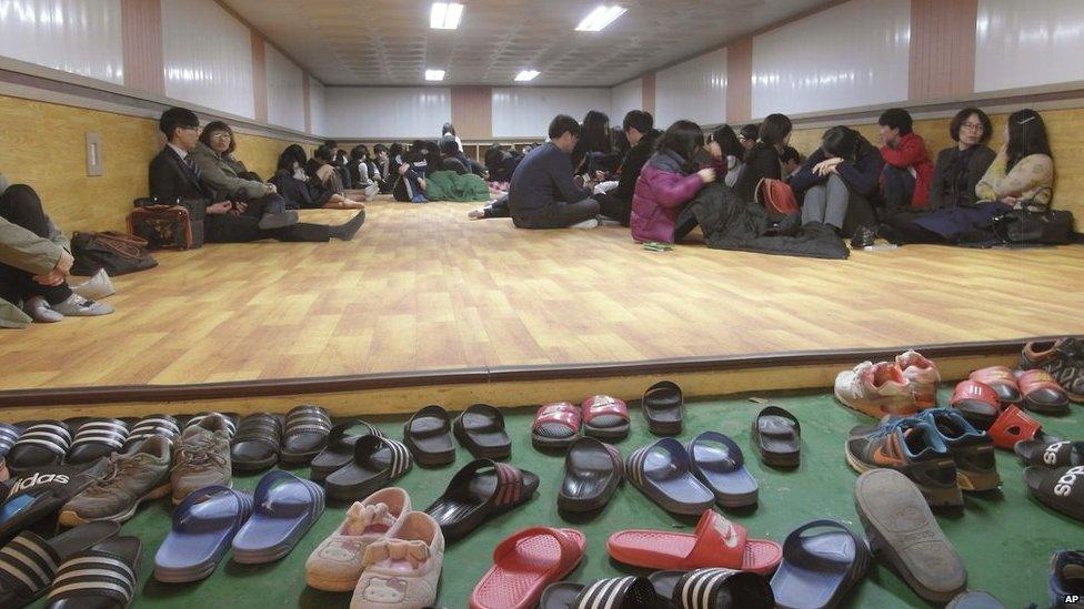 In this photo provided by the Ongjin County, residents of Yeonpyeong Island rest as they evacuate from their homes to a shelter on the island, South Korea, near the West Sea border with North Korea on Monday, 31 March, 2014