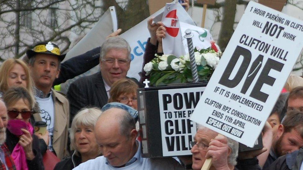 Banners and a "coffin" at the start of the march