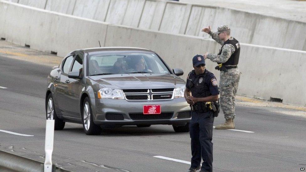 Vehicles are checked outside Fort Hood military base after the shooting there, 2 April