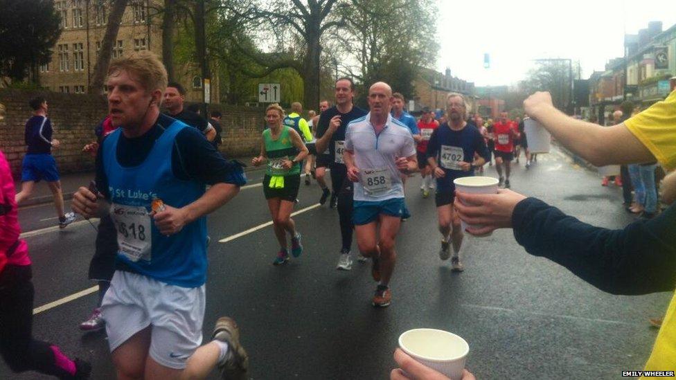 Water being offered to Sheffield runners.