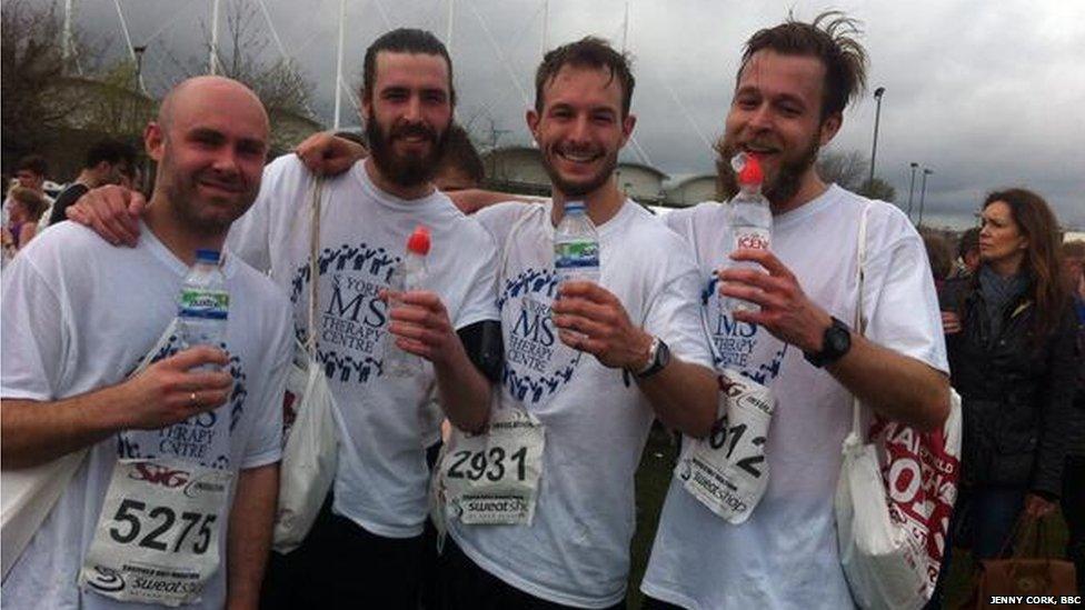 Runners drinking water at the finishing line.