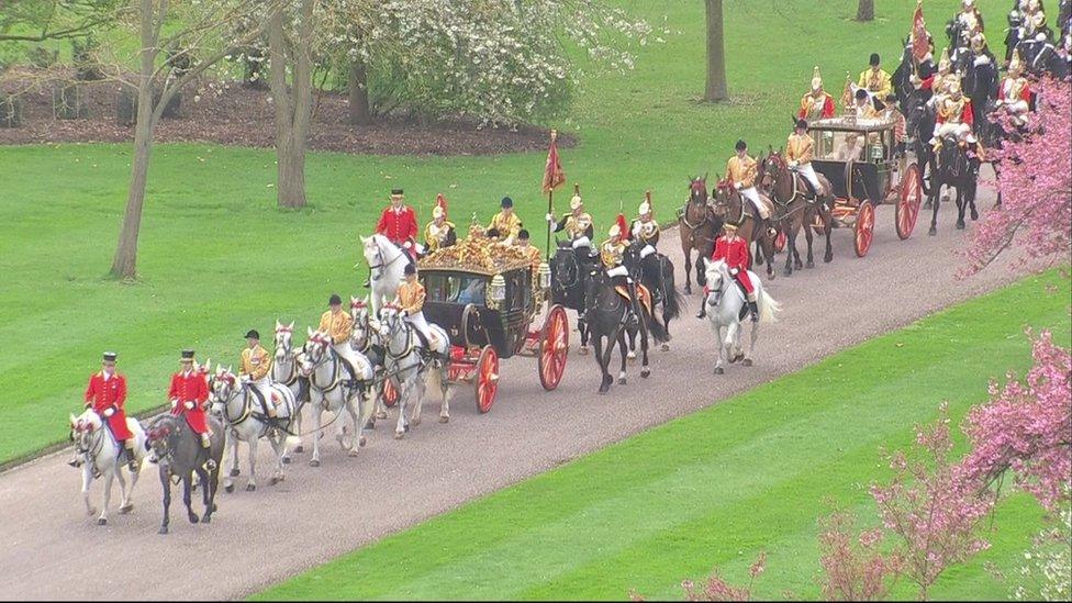 A procession of horses and carriages