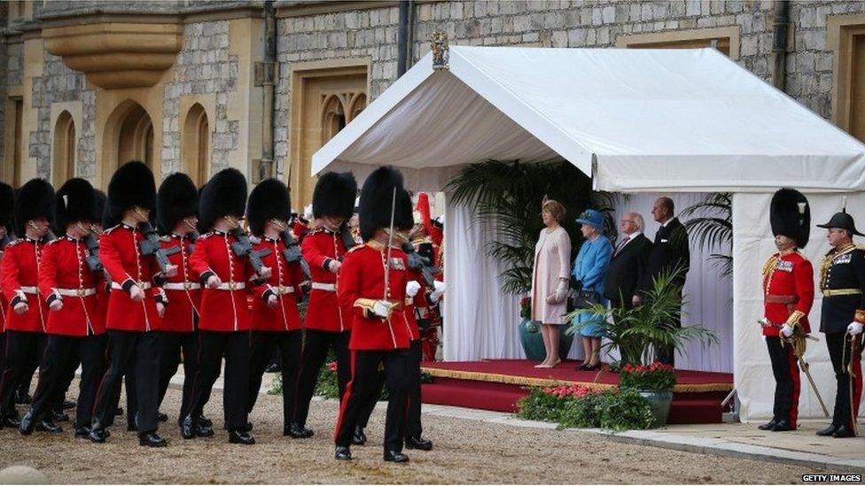 The Queen and Michael D Higgins watching soldiers march past