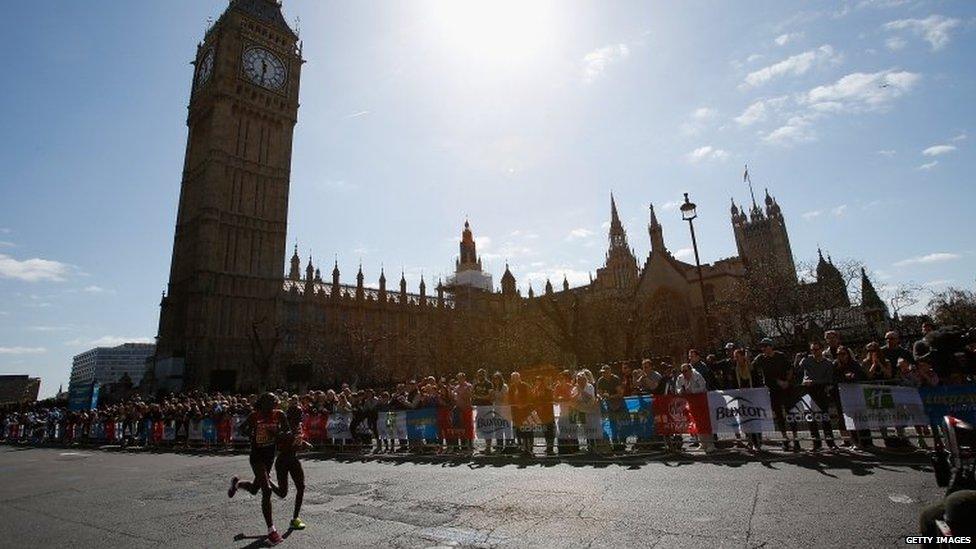 Eventual winner Edna Kiplagat and her namesake Florence Kiplagat, both from Kenya, run past the House of Parliament.