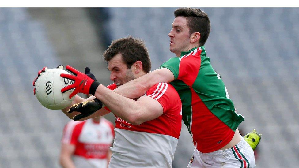 Prolific Derry points-scorer Mark Lynch attempts to shield the ball from Brendan Harrison