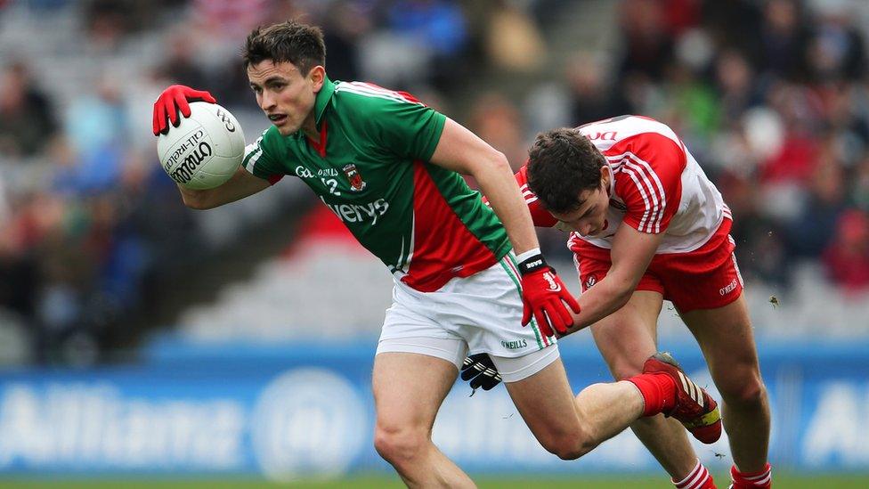 Jason Doherty attempts to make ground at the expense of Derry goal-scorer Kevin Johnston