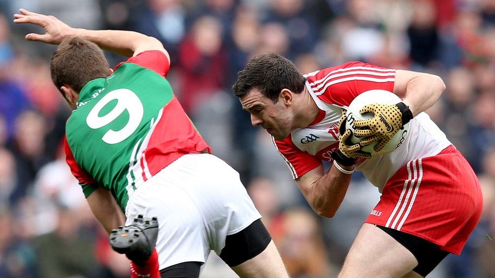 Jason Gibbons and Caolan O'Boyle in action during the first of Sunday's Football League Division One semi-finals