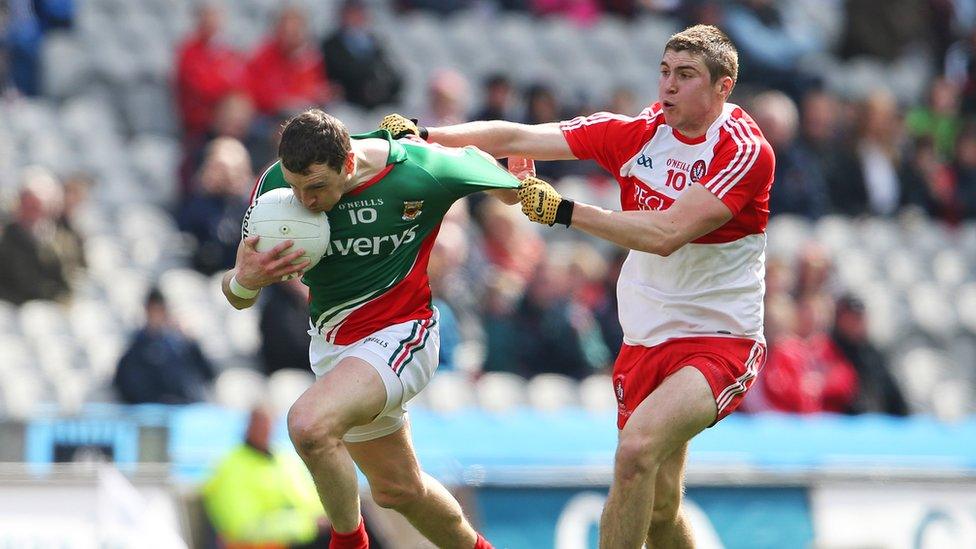 Derry's Ciaran McFaul gets to grips with Keith Higgins in a see-saw encounter at Croke Park