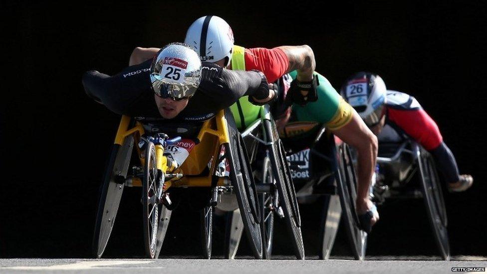 Marcel Hug of Switzerland leads David Weir of Great Britain through Blackfriars tunnel during the London Marathon