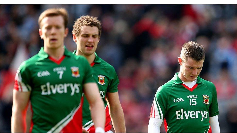 Mayo players leave the field dejected after failing to beat 14-man Derry in Dublin