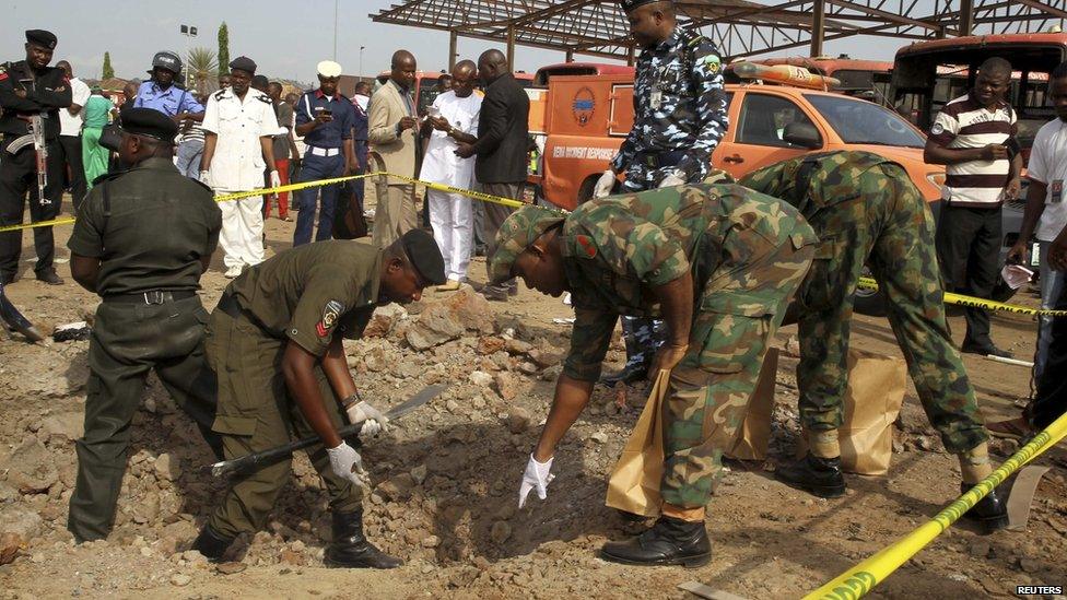 Bomb experts gather evidence at the scene of a bomb blast at Nyanyan in Abuja on 14 April 2014