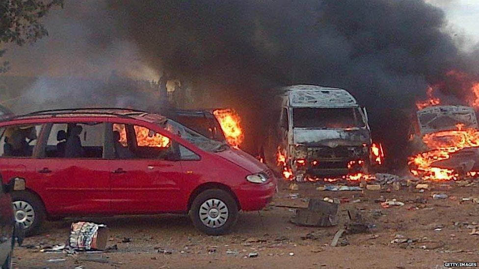 Vehicles burn after an attack at a bus station in Abuja on 14 April 2014.