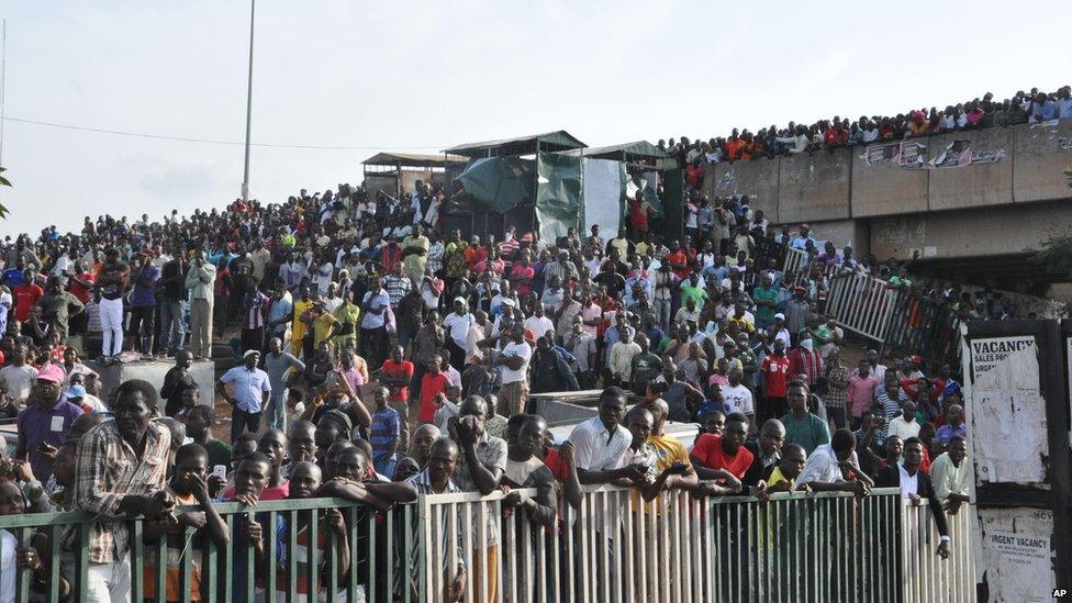 People gathered at the scene of an explosion at a bus park in Abuja, Nigeria, Monday, on 14 April 2014.
