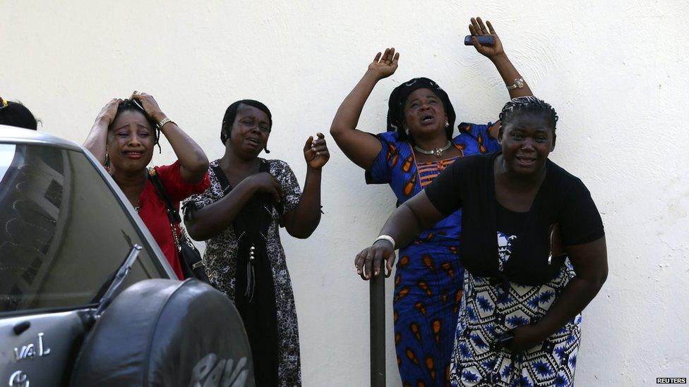 Bystanders react as victims of a bomb blast arrive at the Asokoro General Hospital in Abuja on 14 April 2014.