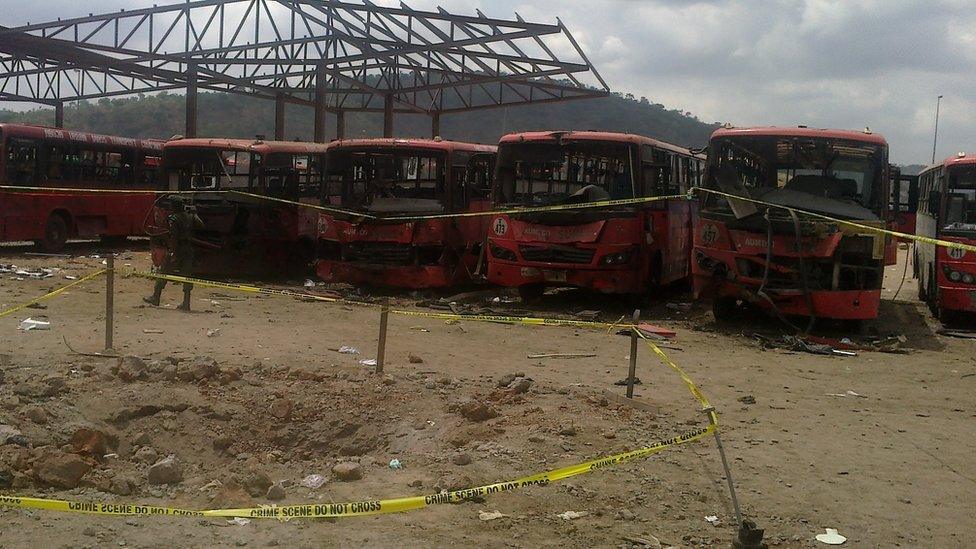 Damaged buses following blast at bus station outside Abuja on 14 April 2014.