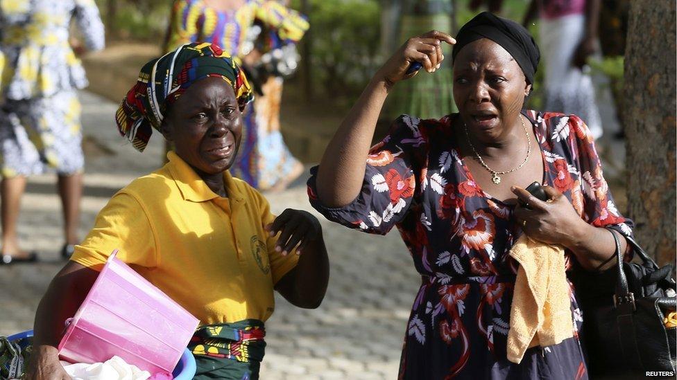 Bystanders react as victims of a bomb blast arrive at the Asokoro General Hospital in Abuja on 14 April 2014.