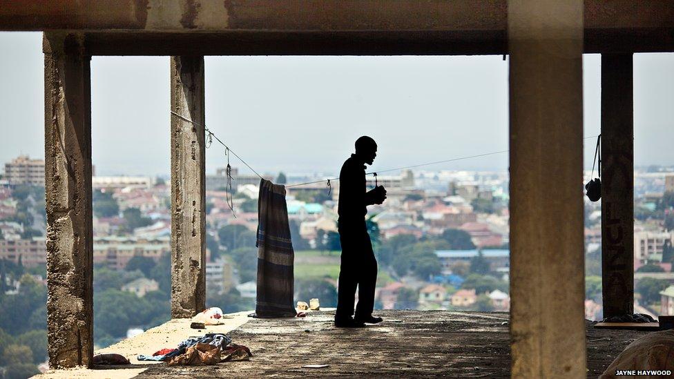 A man paces up and down, holding his bible