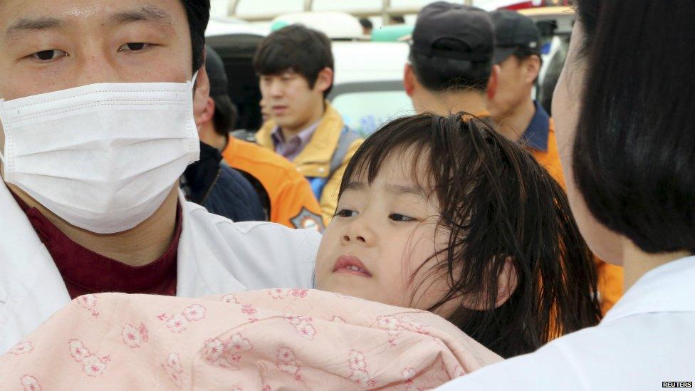 A girl rescued by South Korean maritime policemen from a sinking ship "Sewol" in the sea off Jindo, is treated at a port in Jindo April 16, 2014