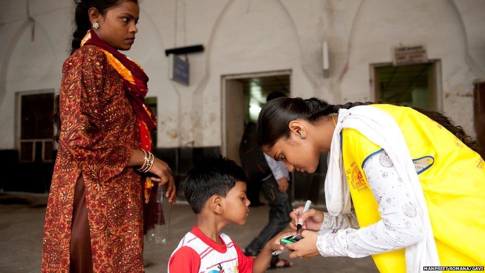 Himanshu, three, has his little finger inked after receiving polio vaccine at the Old Railway Station in Delhi.