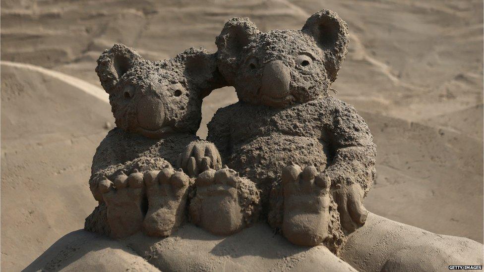 Two koala bears sculpted out of sand