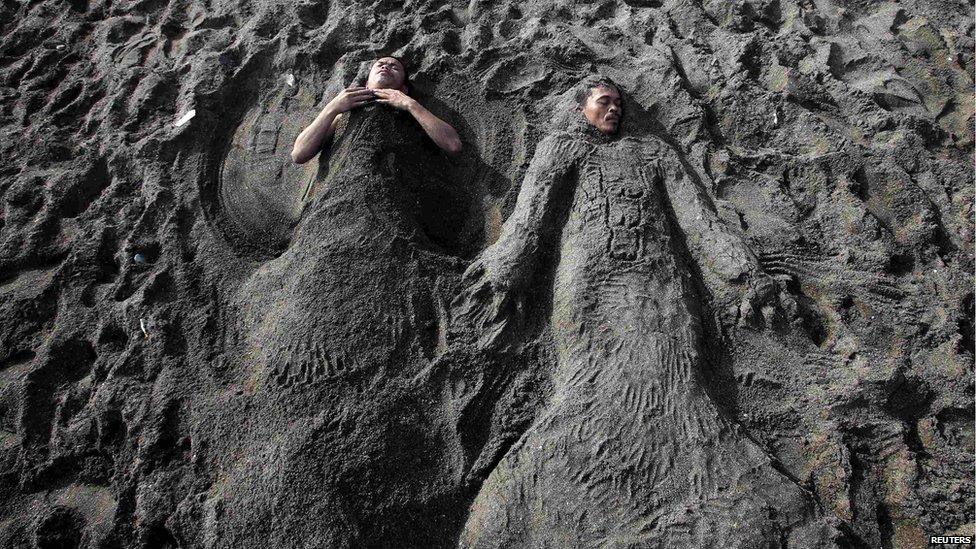 All that swimming must be tiring... These two men took a nap but it looks like someone's turned them into sand mermaids while they were sleeping.