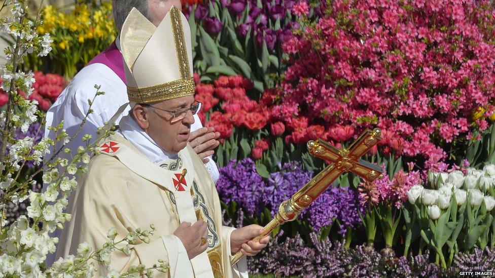 And in Rome, the leader of the Catholic Church Pope Francis walks past flowers as he arrives at St Peter's square to give the traditional Easter mass.