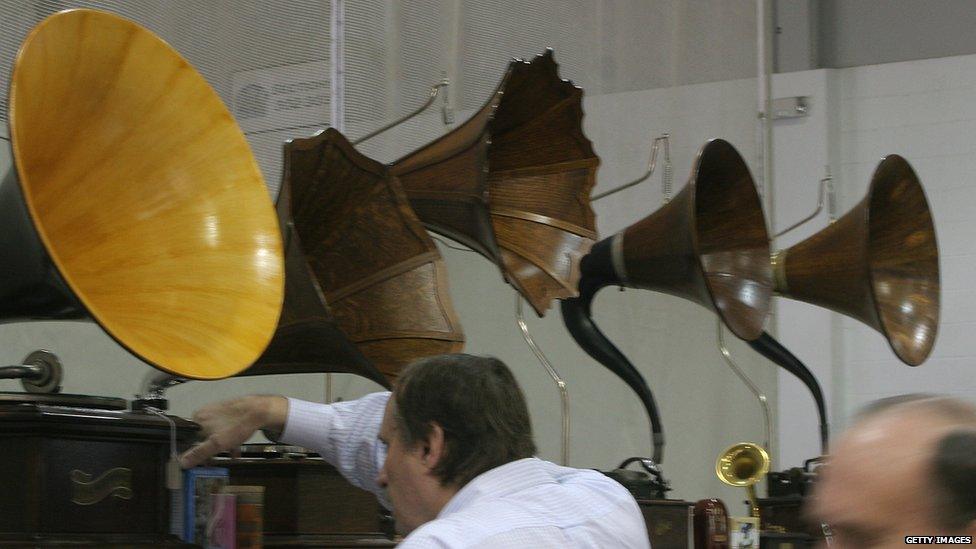 Fairly soon after came the graphophone. The graphophone used wax cylinders which could be played many times, however, each cylinder had to be recorded separately making the mass reproduction of the same music or sounds impossible. This picture shows graphophones dating back to 1890's on display.