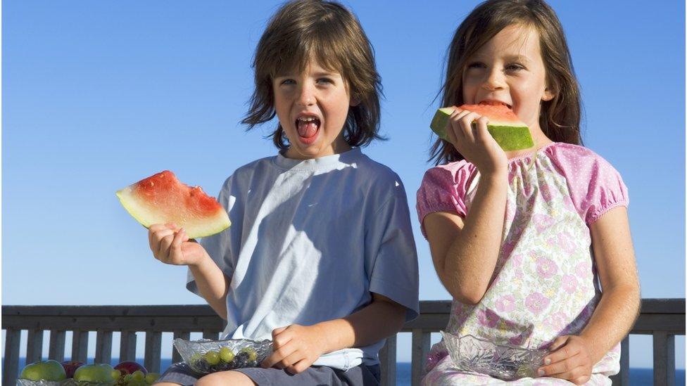 Children eating water melon