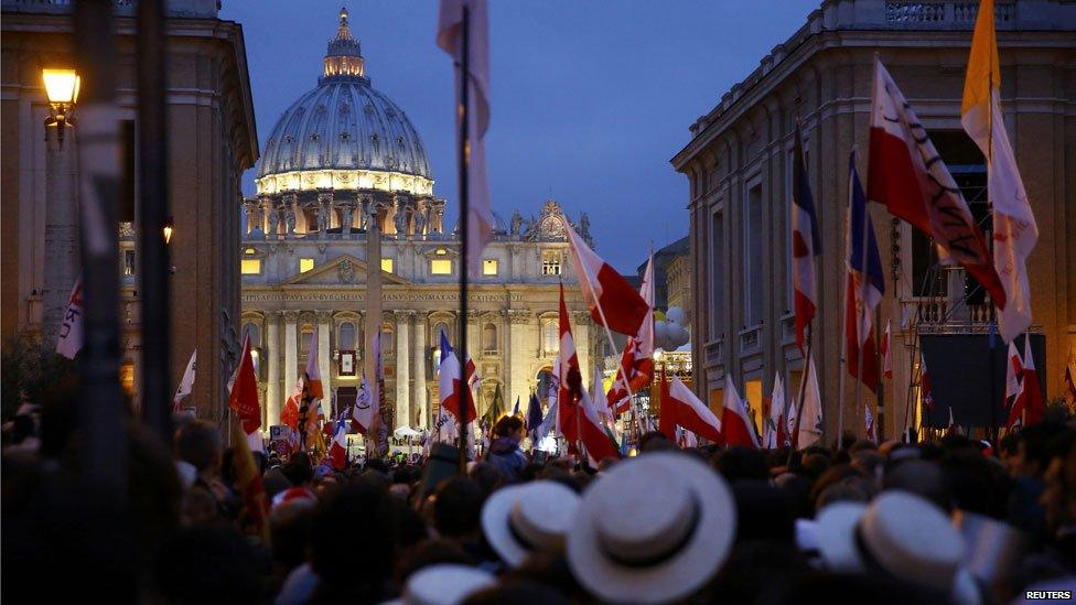 Polish pilgrims wait for mass before the canonisation ceremony in St Peter's Square at the Vatican, April 27