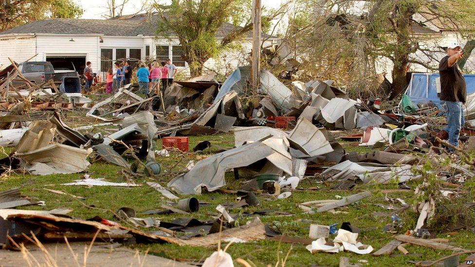 Residents survey the damage in a residential neighbourhood in Quapaw struck by a tornado on 27 April