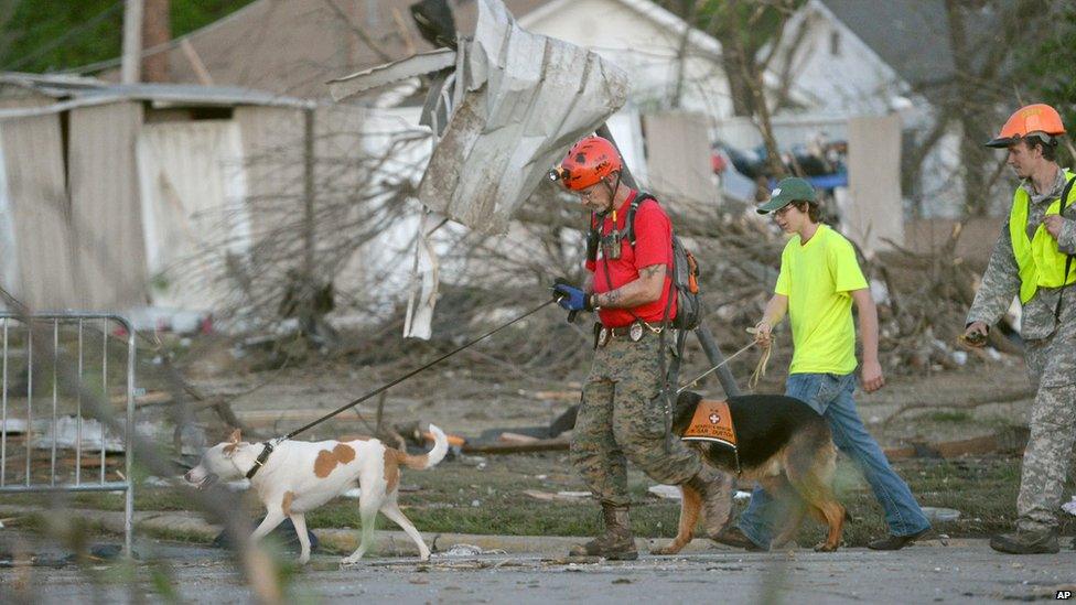 A K-9 rescue unit walks along Military Street in Baxter Springs, Kansas, on 27 April