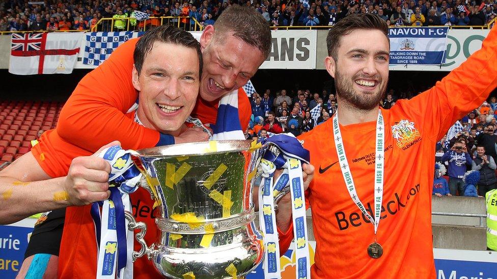 Glenavon's cup final goal scorers Kyle Neill and Mark Patton celebrate with skipper Kris Lindsay after the 2-1 victory over Ballymena United