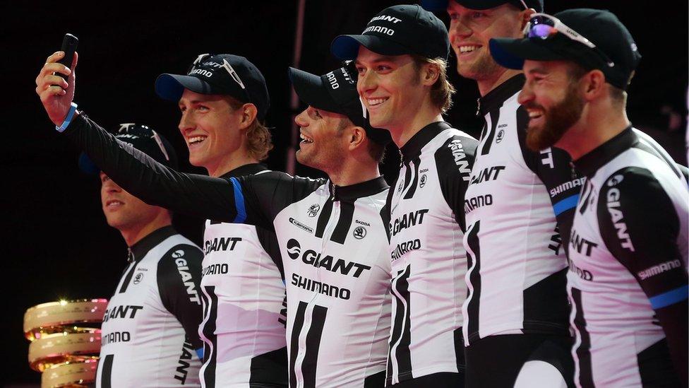 A Giant Shimano team member takes a 'selfle' in front of the huge crowd at the Giro d'Italia 'Meet the Riders' ceremony in Belfast