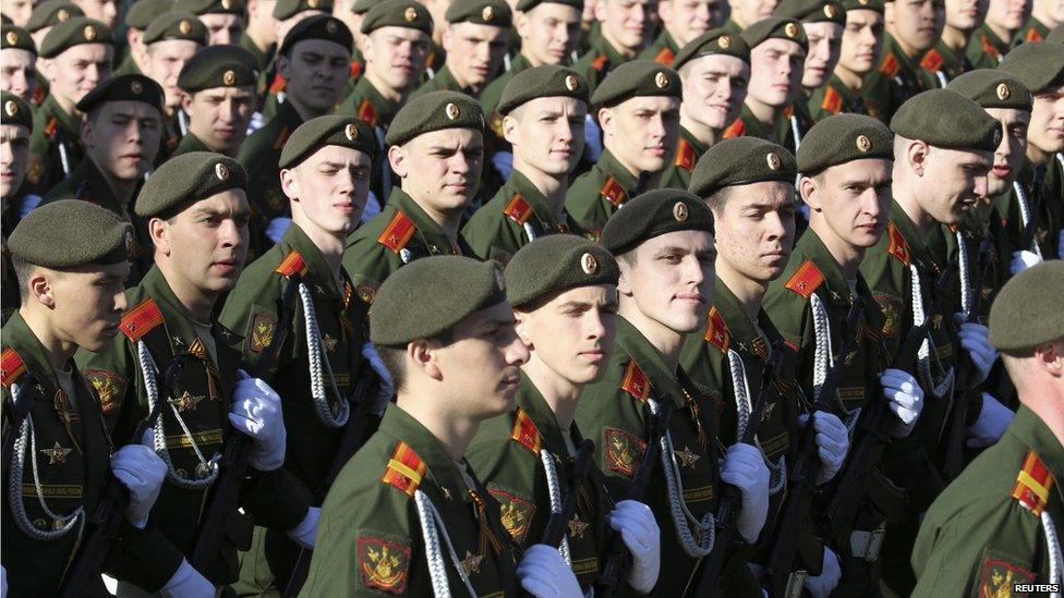 Russian servicemen march during the Victory Day parade in Moscow's Red Square, 9 May 2014