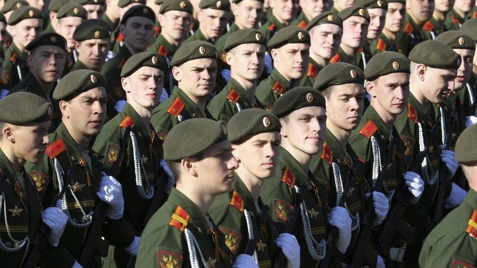 Russian servicemen march during the Victory Day parade in Moscow's Red Square, 9 May 2014