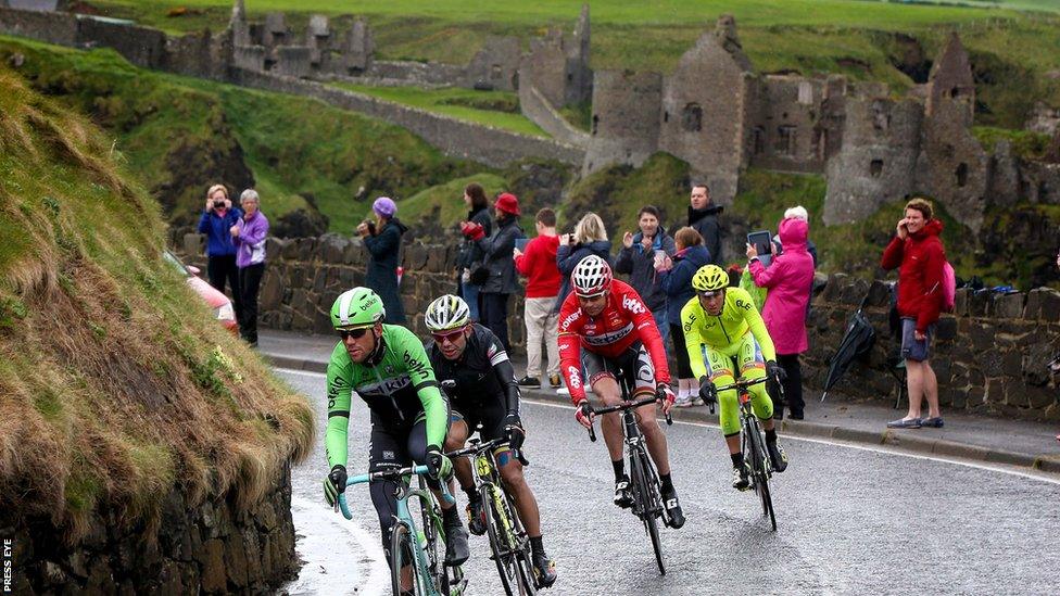 Breakaway riders Jeffry Johan Romero Corredor, Maarten Tjallingii, Sander Armee and Andrea Fedigo past Dunluce Castle during stage two of the Giro d'Italia in Northern Ireland