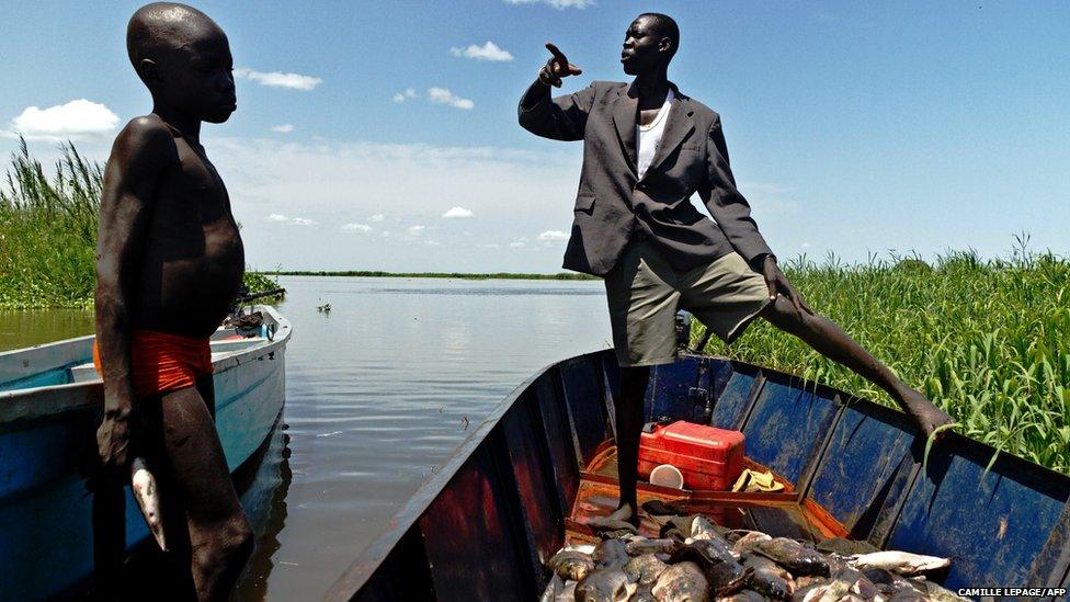 A man and boy from the Mundari tribe are pictured with their catch in Terekeka