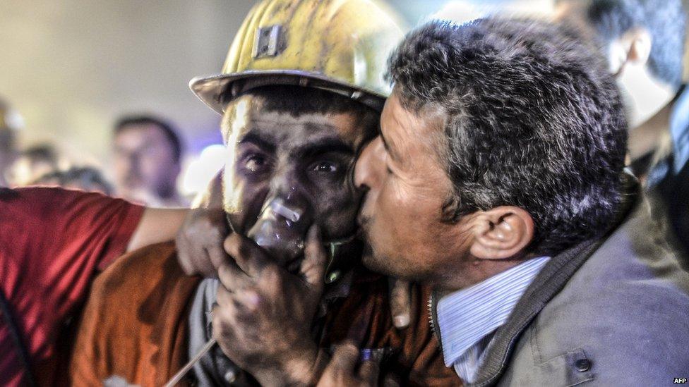 Man kisses his son rescued from the coal mine in Soma, Manisa province, Turkey, on 14 May 2014