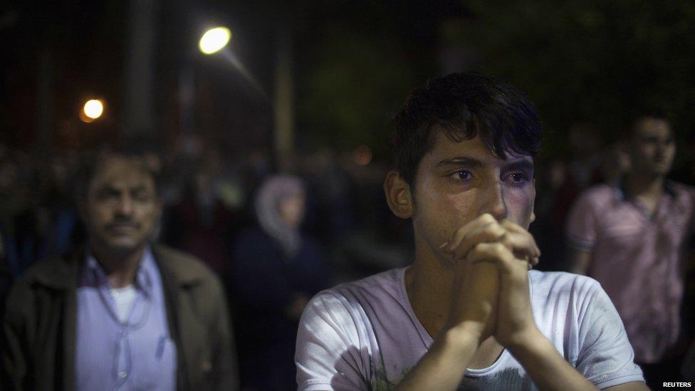 Relatives of miners react as they wait in front of a coal mine in Soma, a district in Turkey's western province of Manisa early May 14