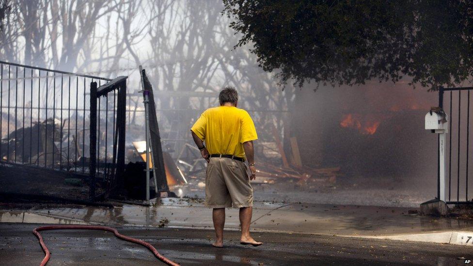 A man watched a house burn in Carlsbad, California, on 14 May 2014