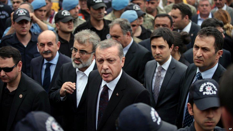 Prime Minister Erdogan, centre, is surrounded by security members as he visits the coal mine in Soma - 14 May 2014