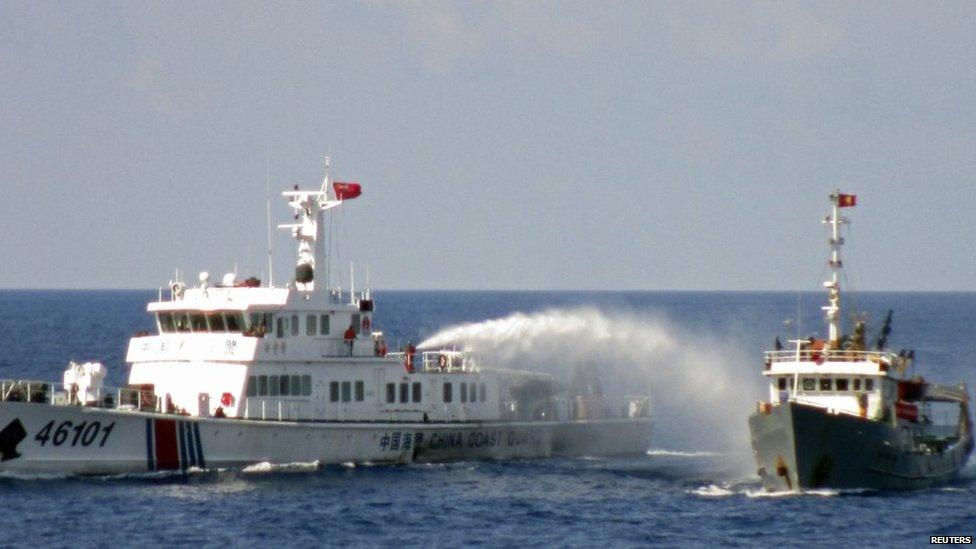 A Chinese coastguard vessel (L) uses water cannon on a Vietnamese Sea Guard ship on the South China Sea near the Paracels islands, in this handout photo taken on 4 May, 2014 and released by Vietnam Marine Guard on 8 May, 2014