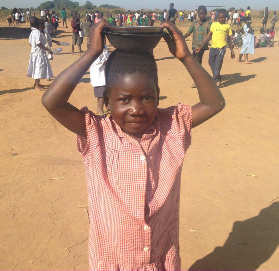 A girl in Malawi, Africa, dressed in a Leicestershire school uniform