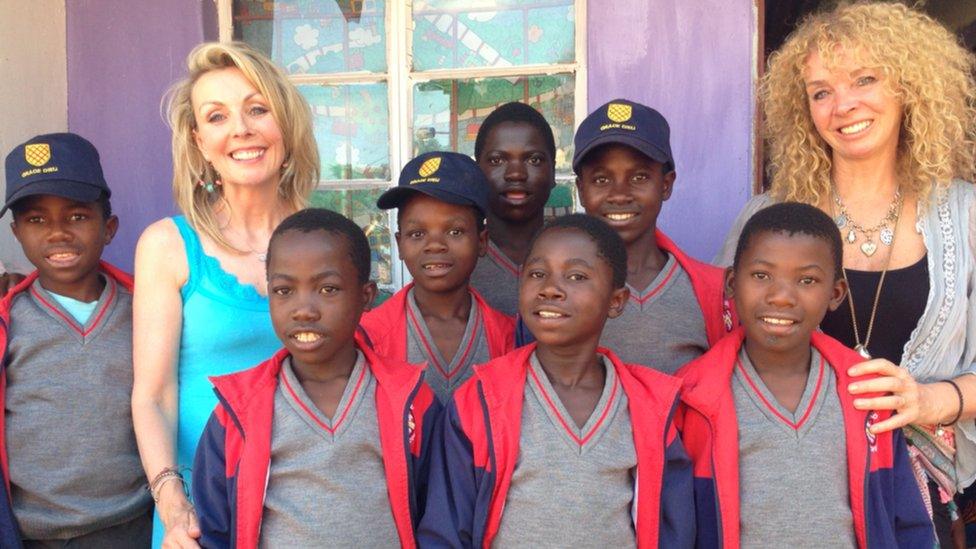 BBC East Midlands Today presenter Anne Davis pictured with Alice Pulford's mother Yvonne and orphaned boys in Malawi, Africa