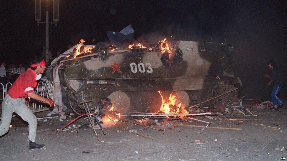 An armoured personnel carrier in flames on 4 June 1989 near Tiananmen Square