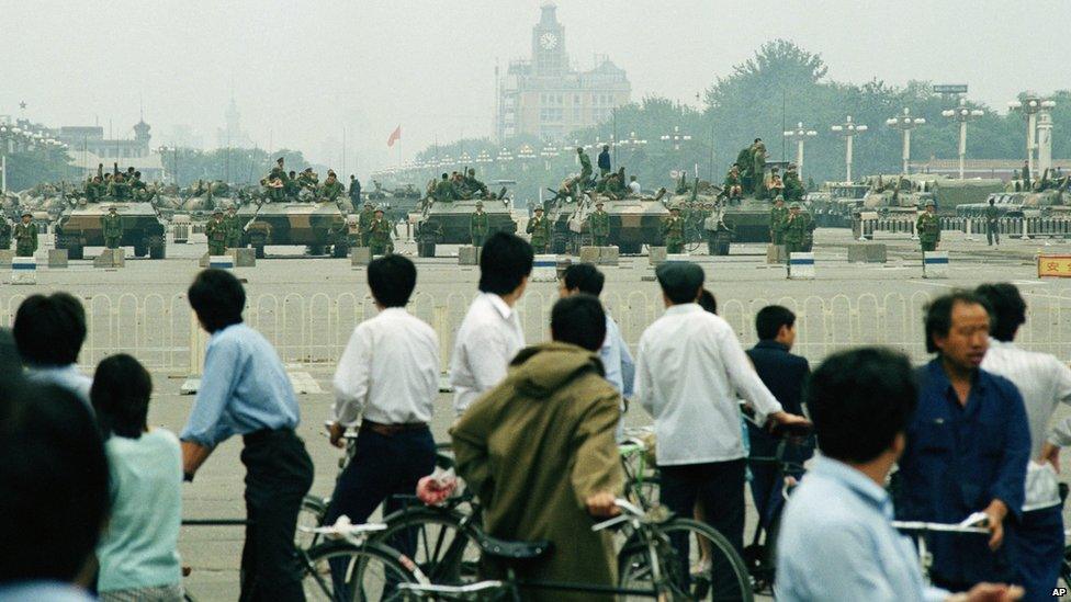 Curious residents gather in Tiananmen Square on 7 June 1989, after soldiers and tanks had cleared the area of striking students