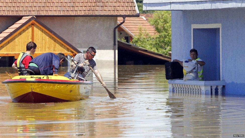 Man waits to be rescued from his house in Vojskova, Bosnia. 19 May