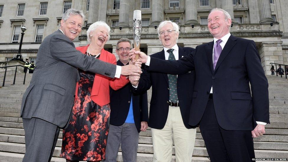 Peter Robinson, Olympic champion Mary Peters, Chris Jenkins, Robert McVeigh and Martin McGuinness hold the Queen's baton on the steps of Stormont, Belfast, Northern Ireland