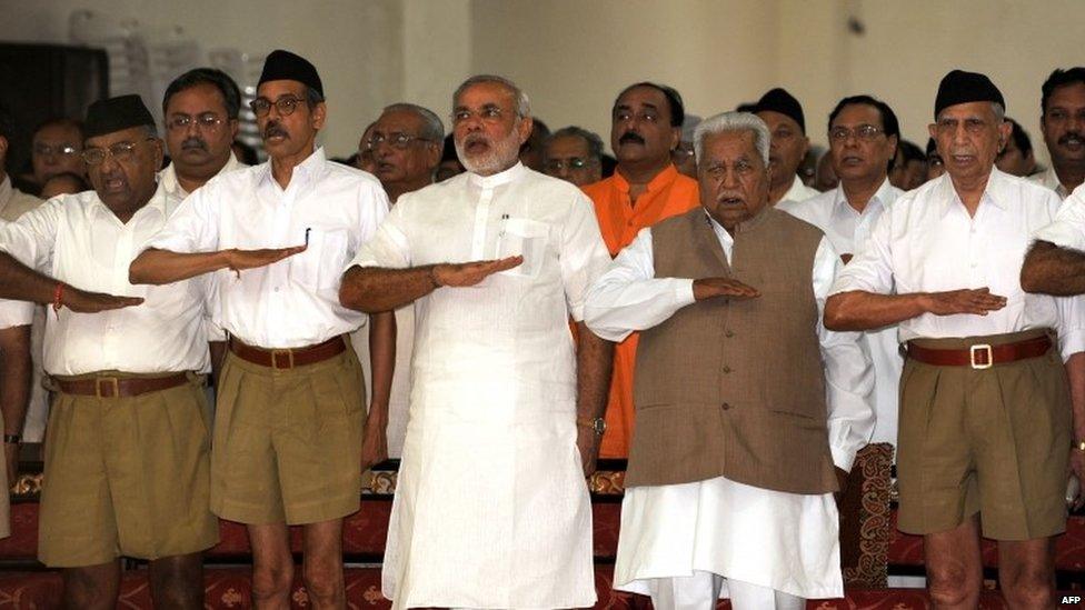 In this photograph taken on September 6, 2009, Chief Minister of the western Indian state of Gujarat Narendra Modi (3L) and former chief minister Keshubhai Patel (2R, front) gesture as they attend a Rashtriya Swayamsevak Sangh (RSS) gathering at Tria Mandir in Adalaj, some 20kms from Ahmedabad.